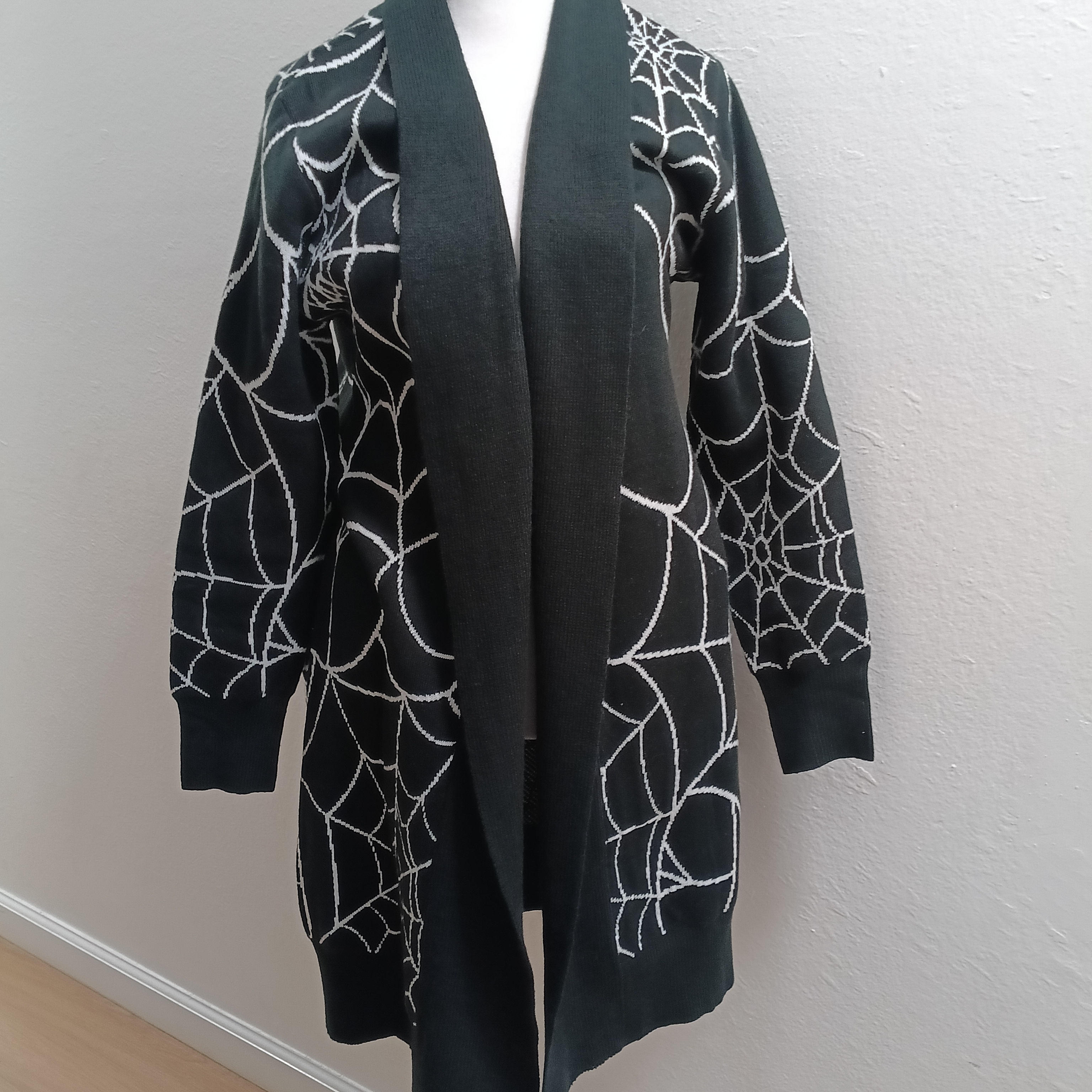 Elegant Black Cardigan With White Web Design